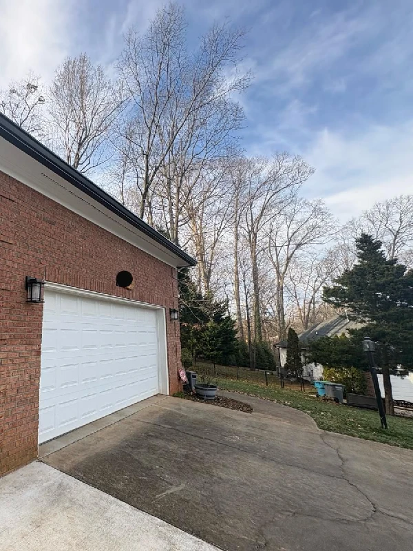 Black seamless gutter installation with gutter guards in Charlotte NC